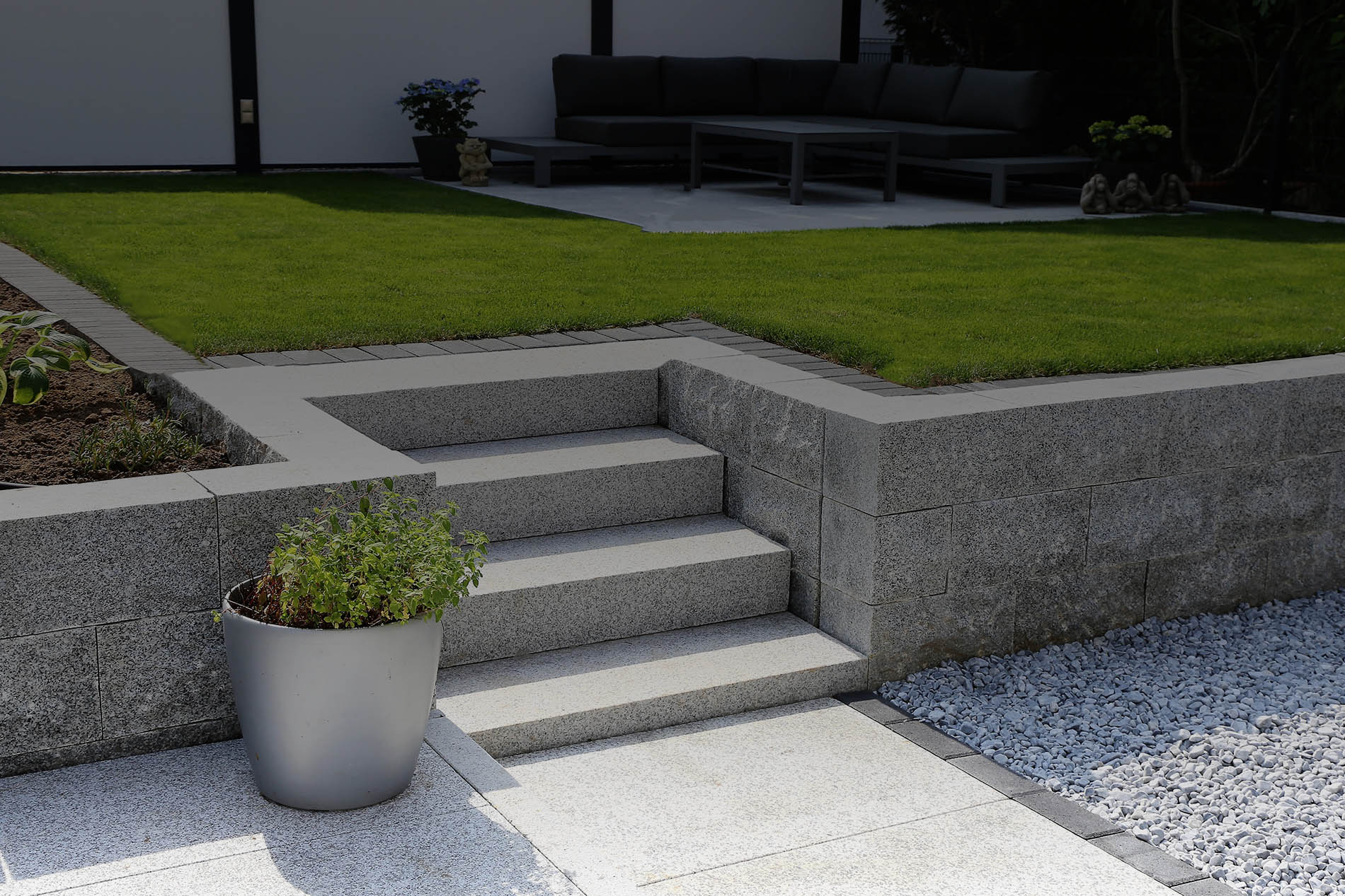 Neat and tidy garden with granite wall and solid block steps
